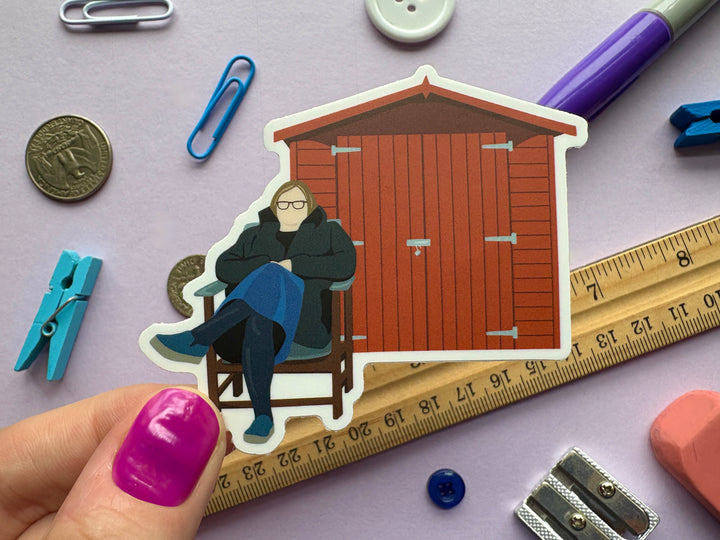 Liza Tarbuck sitting outside a shed for no particular reason Sticker