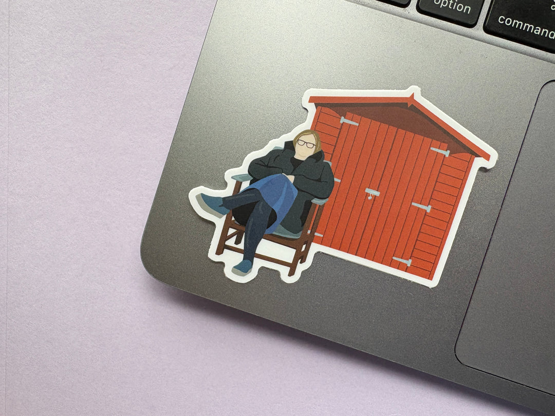 Liza Tarbuck sitting outside a shed for no particular reason Sticker