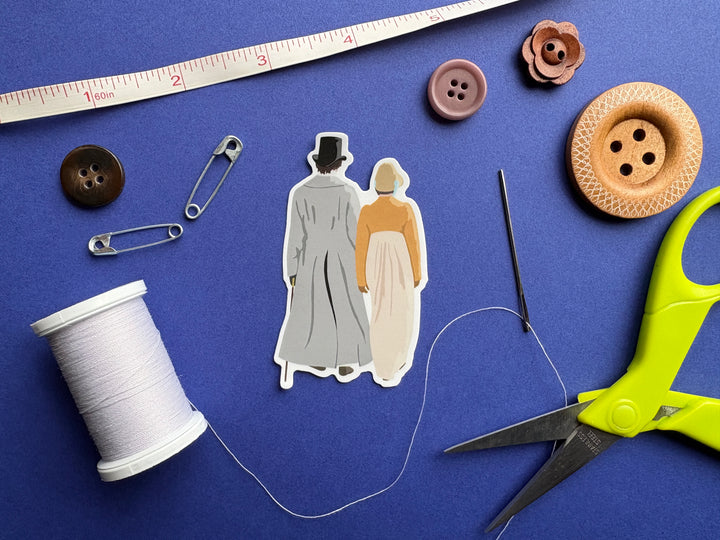 A cartoon of Mr Darcy and Elizabeth from Pride and Prejudice 1995 walking down the lane shown from behind. Shown on a blue background surrounded by small sewing notions.