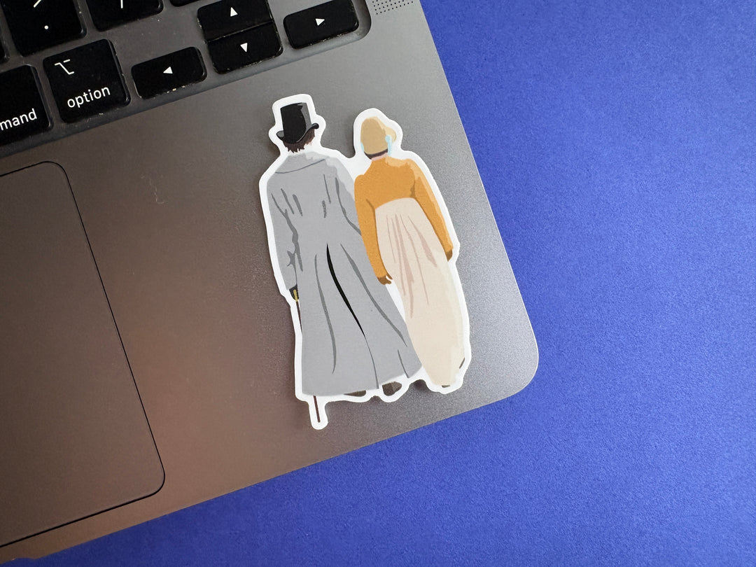 A cartoon of Mr Darcy and Elizabeth from Pride and Prejudice 1995 walking down the lane shown from behind. Shown on a silver laptop resting on a blue background.