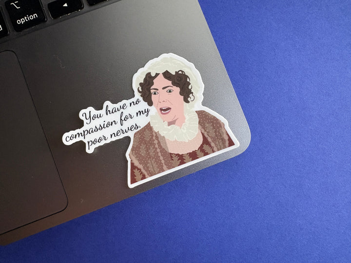 A cartoon of Mrs. Bennet from Pride and Prejudice 1995 with the text 'you have no compassion for my poor nerves'. The sticker is resting on a silver laptop on a blue background.