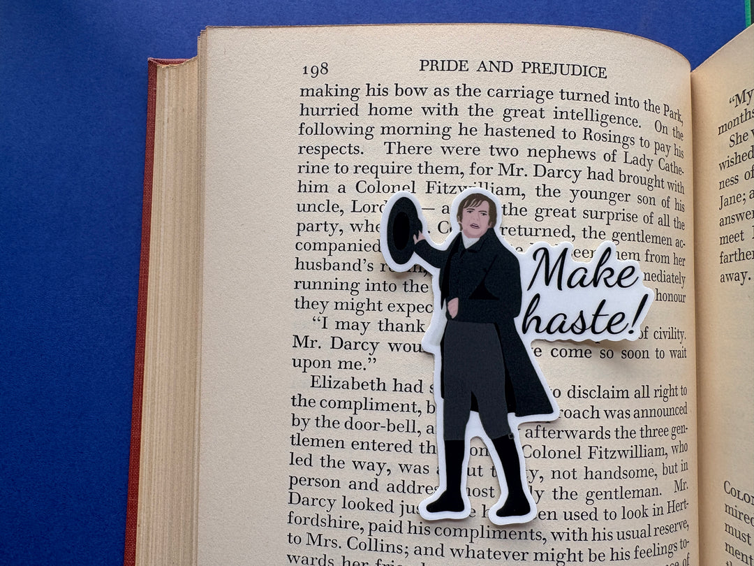 A sticker of Mr Collins from Pride and Prejudice 1995 with the text 'Make haste'. Sitting on an open book resting on a blue background.