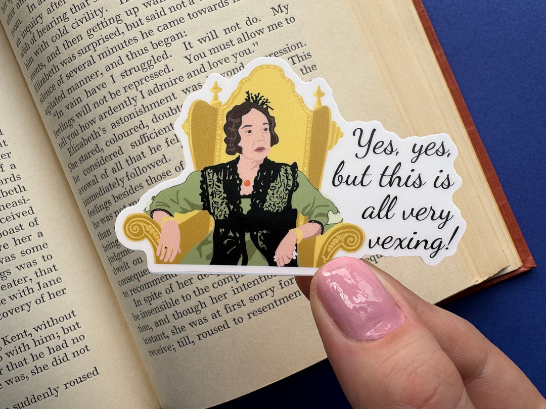 A cartoon of Lady Catherine from BBC Pride and Prejudice 1995 with the text 'yes, yes, but this all very vexing!'. She is sitting in a gold chair and wearing a green dress. The sticker is held over a book on a blue background. 