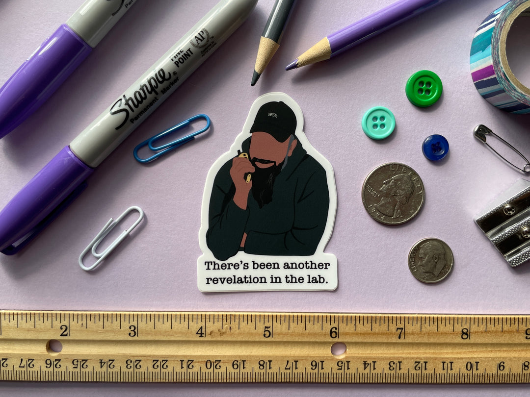 A sticker of a cartoon of comedian Guz Khan holding a walkie talkie with the text "there's been another revelation in the lab" belowis shown on a purple background surrounded by small objects.