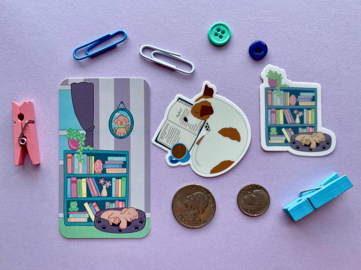 Three items shown on a purple background surrounded by objects. The items are a bookmark with a bookshelf and dog, and two stickers of sleeping dogs with books.