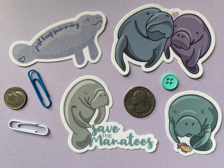 Four cartoon manatee stickers on a purple background surrounded by small objects.